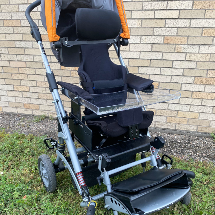 Stroller with custom molded black seat and clear plastic tray 
