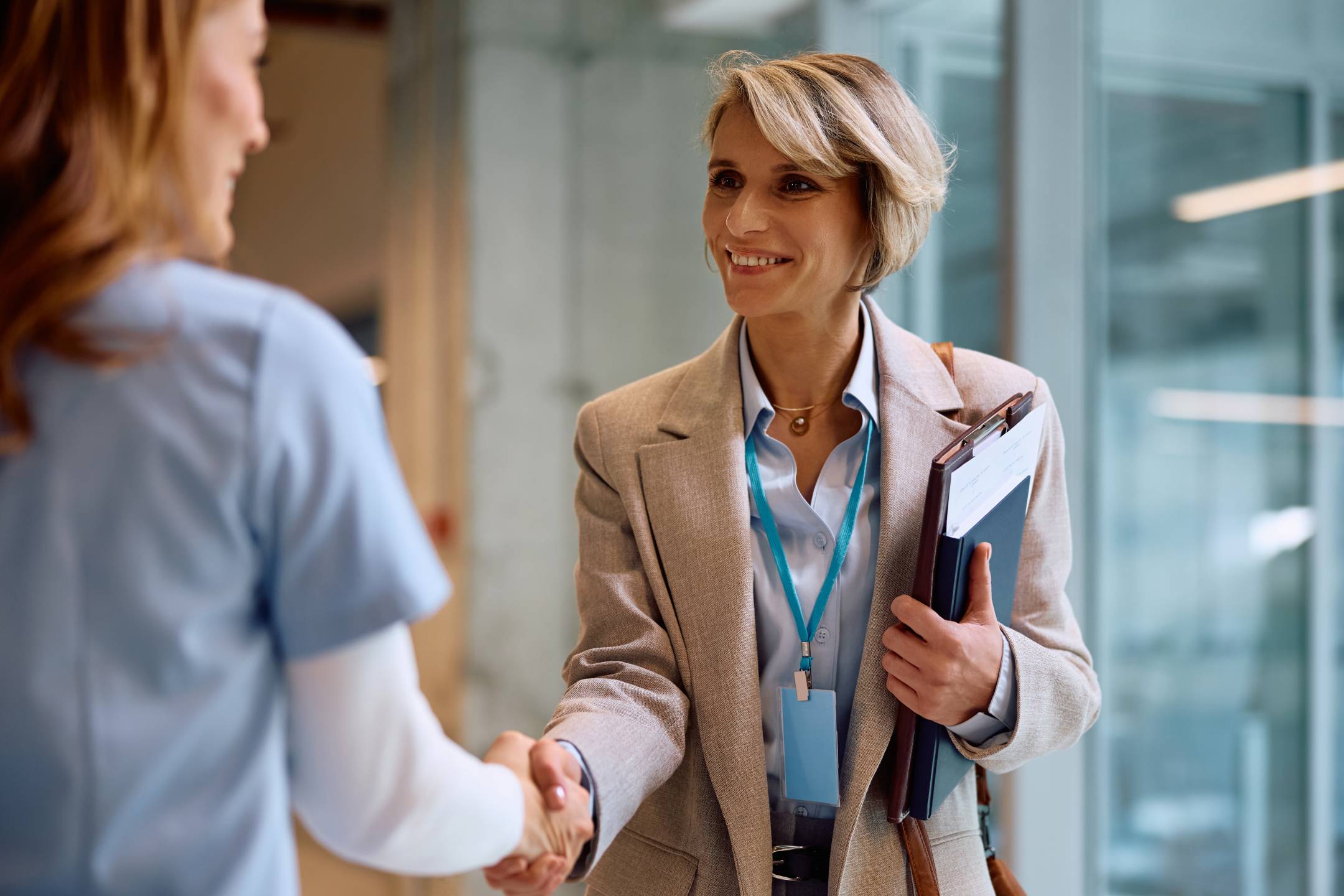 Two women shaking hands.