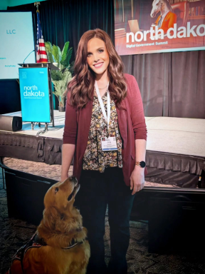 Emily Riedman with her service dog Bentley at ND Digital Government Summit.