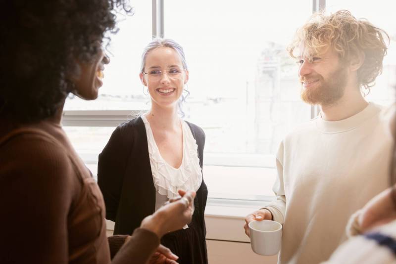 group of three people talking