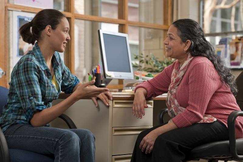 Mother talking to counselor at clinic.