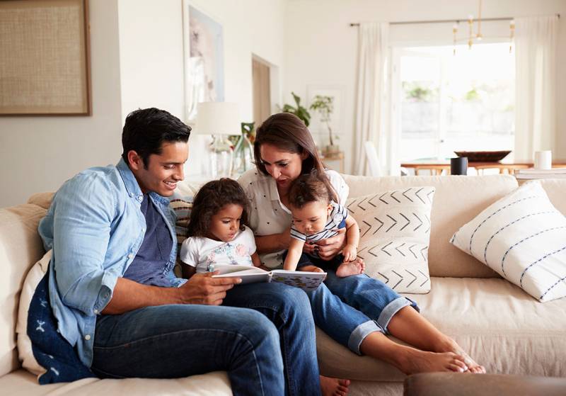 Parents Reading Book to Children