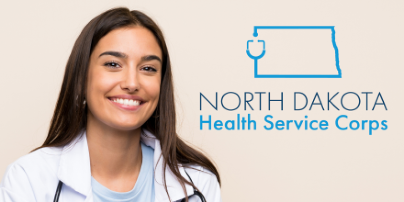 Young woman in a while physician coat with a stethoscope next to the ND Health Services Corps logo
