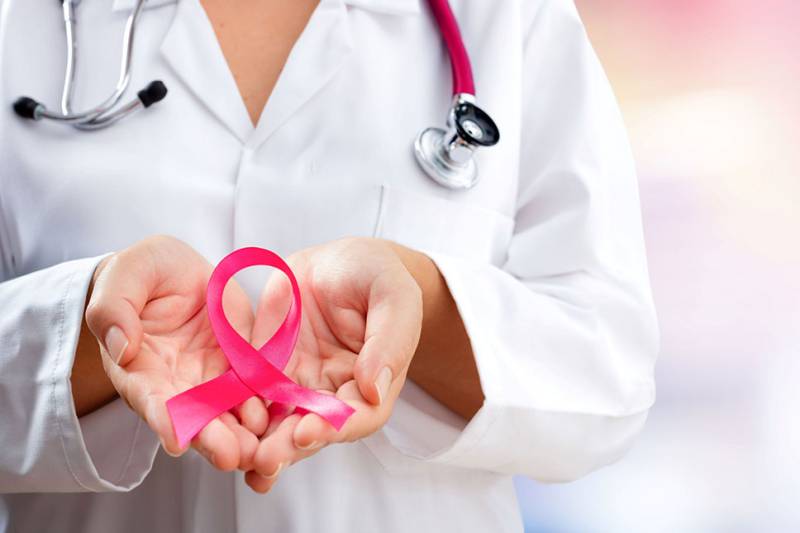 Provider holding a pink ribbon