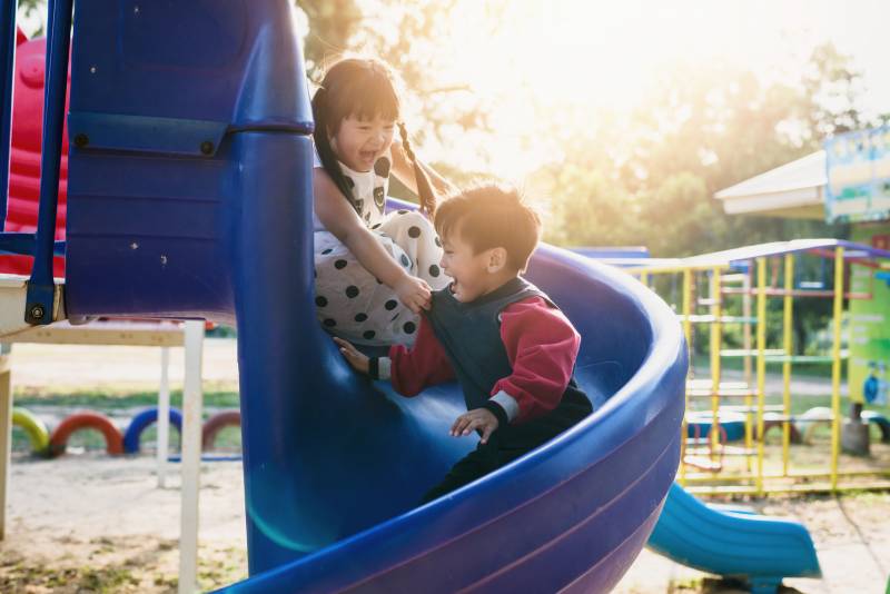 children play on a slide