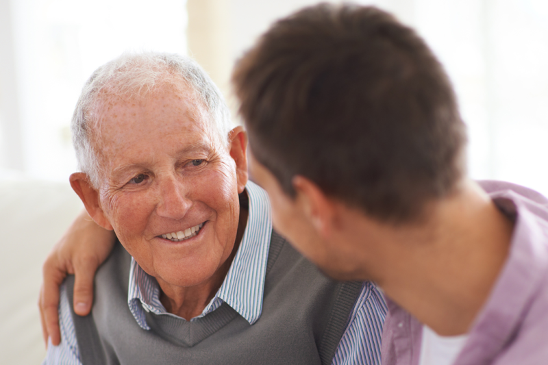 Family member comforting elderly parent