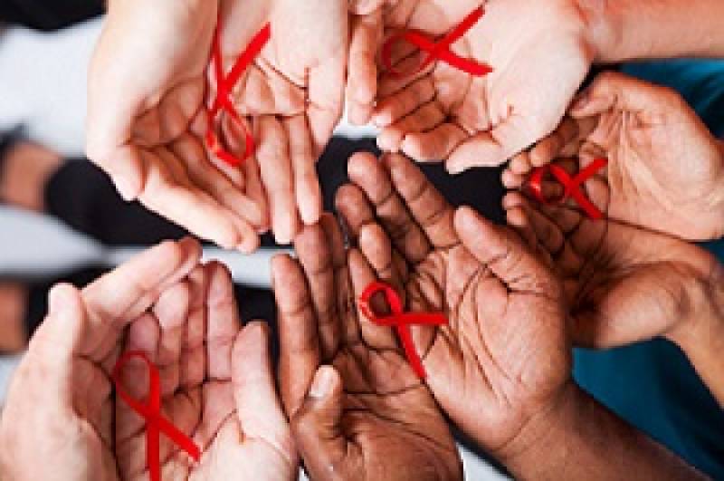 In a circle, five pairs of hands palm up with red ribbon