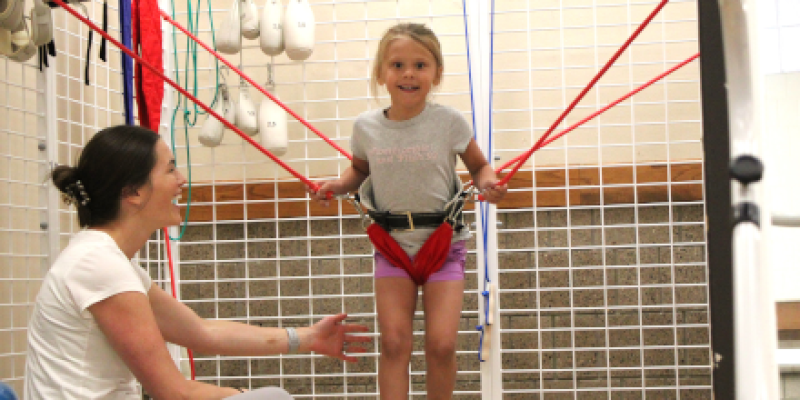 Therapist treating young child with bounce therapy 