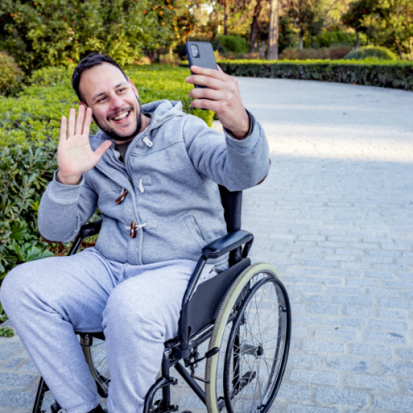 Man in wheelchair taking selfie