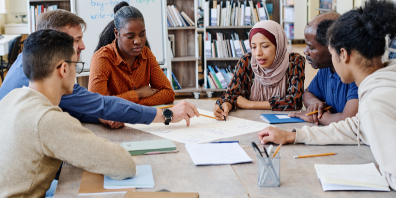 People Sitting Around a Table Learning Together