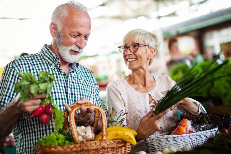 older adult couple grocery shopping for healthy food