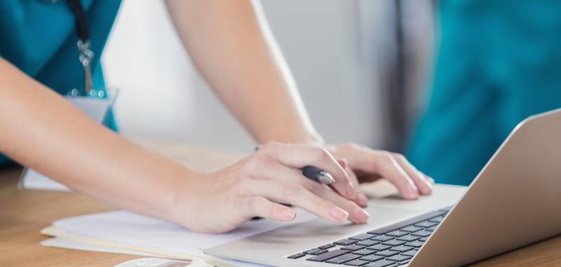 Nurse typing on computer