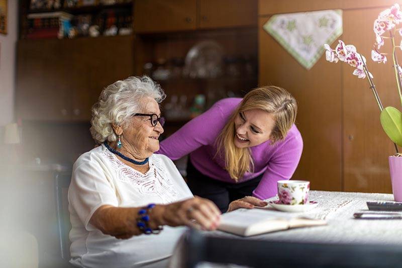 older-woman-sitting-with-caregiver