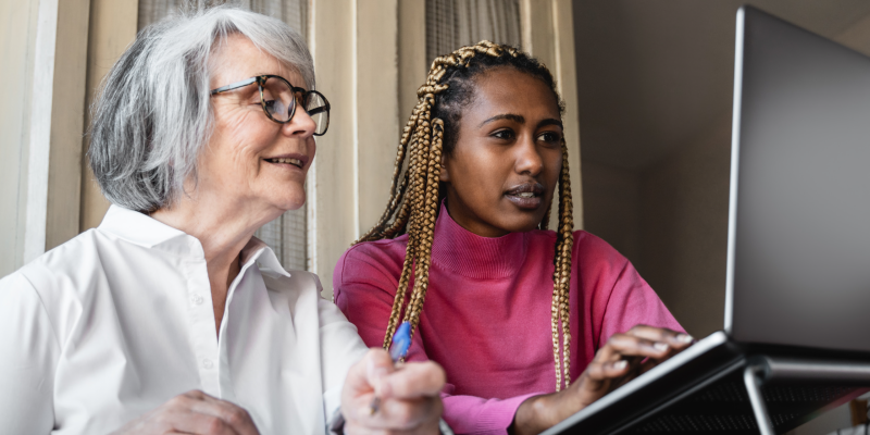 two women looking at a laptop together