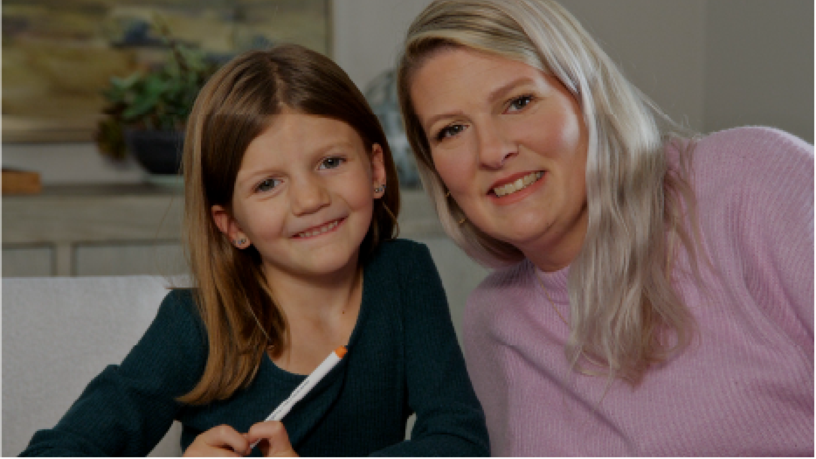 mother and daughter smiling at the camera