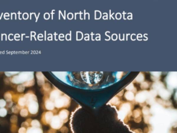 Cover of ND Cancer Data Inventory document. A gloved hand is holding a large round magnifying glass up to the sky.
