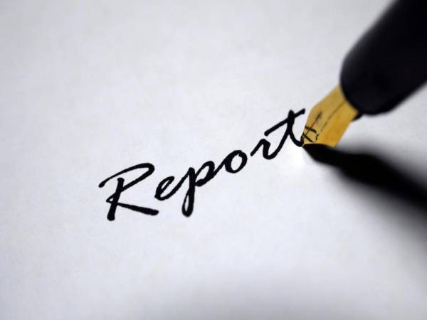 The word 'report' written on a paper.