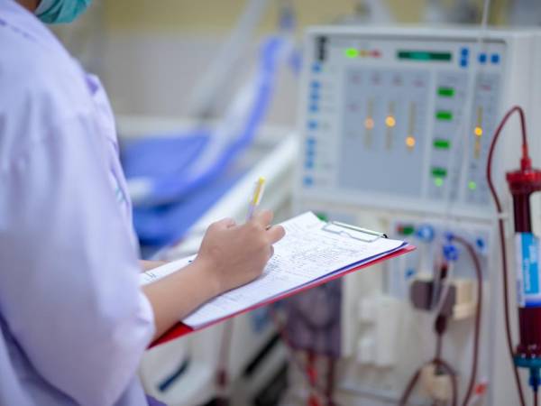 A person viewing a dialysis machine. 
