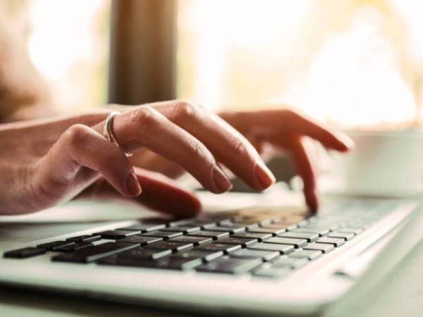 Hands typing on a keyboard.