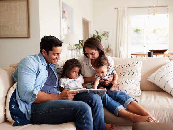 Parents Reading Book to Children