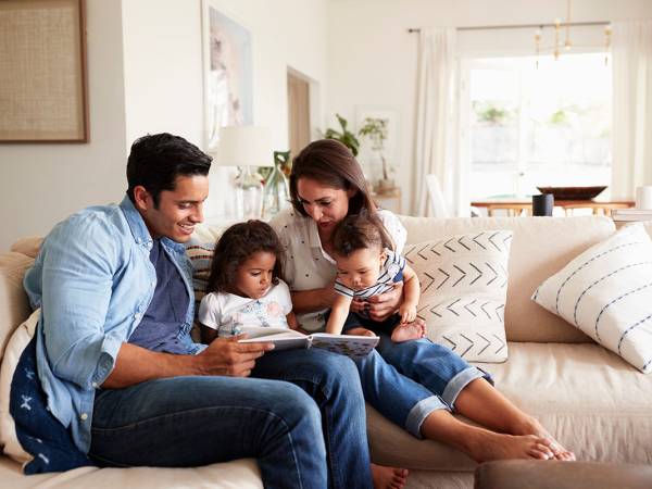 Parents Reading Book to Children