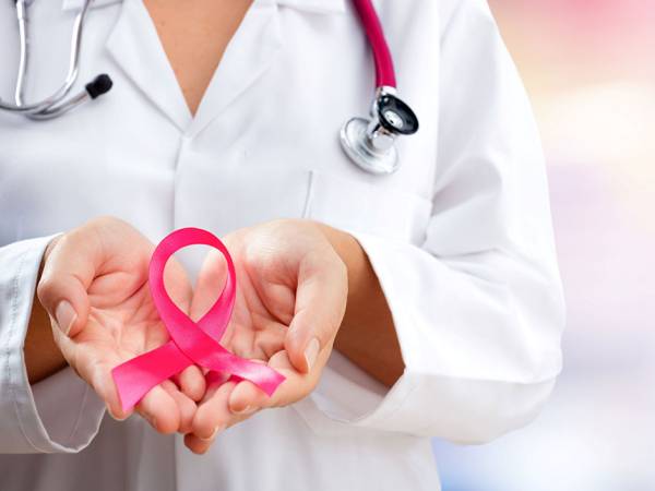 Provider holding a pink ribbon