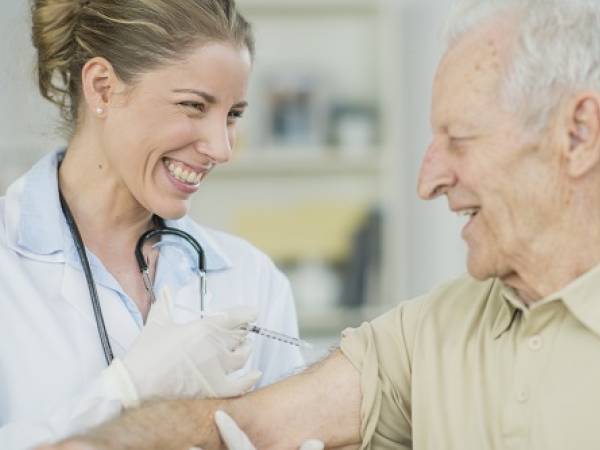 Older adult male receiving vaccine