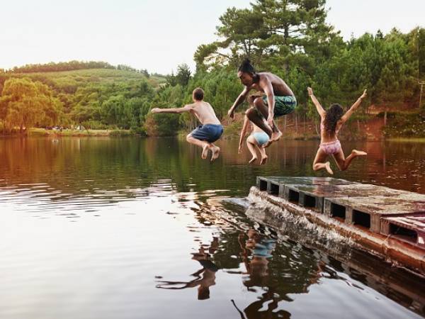 Kids jumping into lake