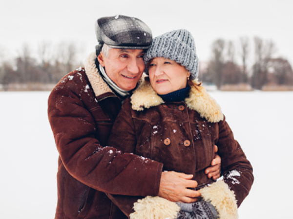 Image of a man hugging a woman outside in the winter