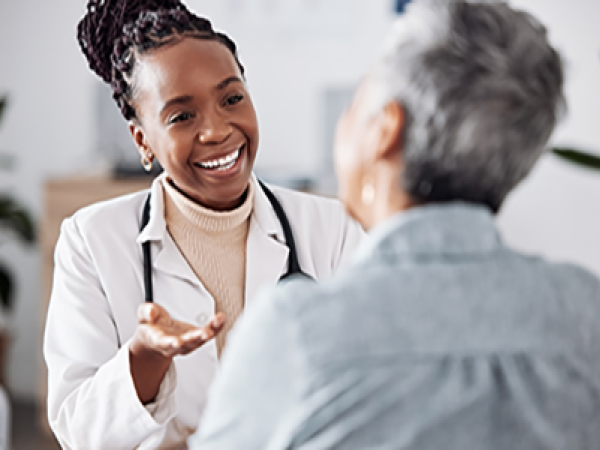 A doctor speaks with her patient