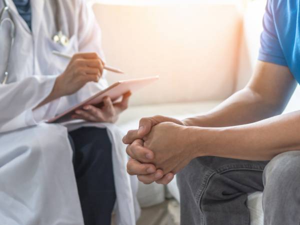 A doctor consults with her patient