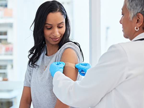 woman getting a bandage after a vaccine