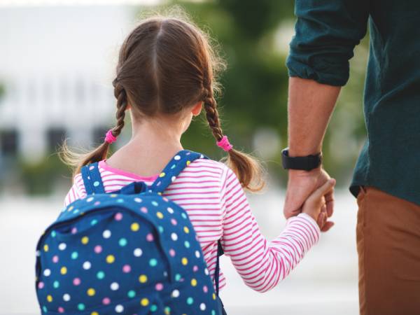Young child holding adult's hand