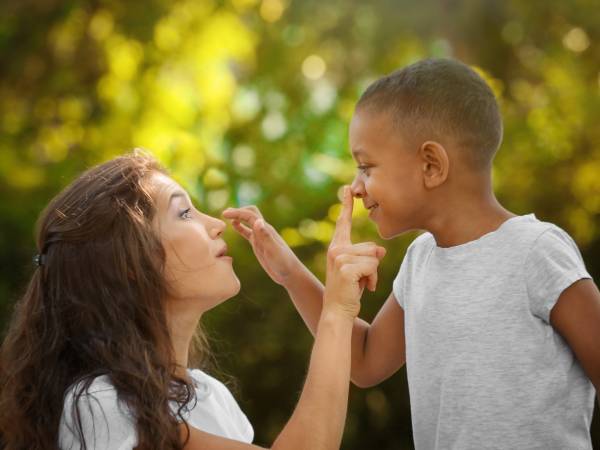 a child and parent interact playfully