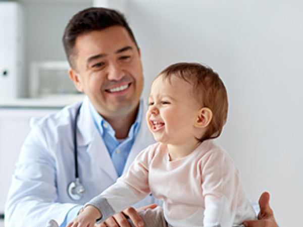 Physician with toddler at check-up