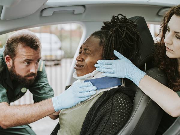 EMTs assist a woman following a collision