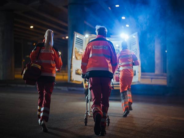 EMTs approach an ambulance