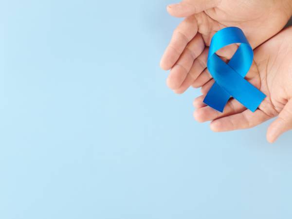 hands holding a blue ribbon 