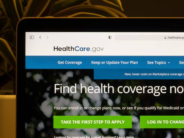 The homepage of HealthCare.gov, a health insurance exchange website operated under the United States federal government, is seen on a laptop computer
