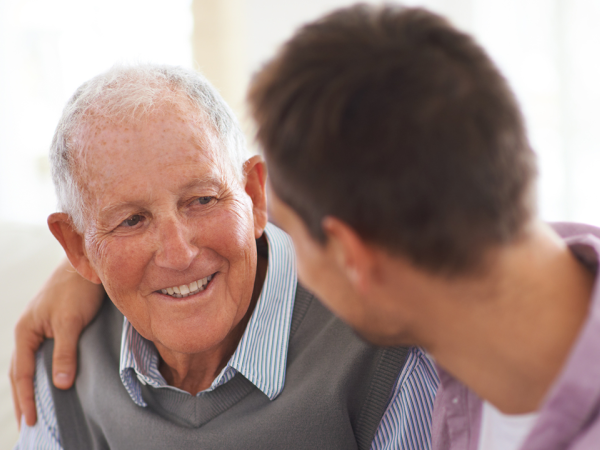 Family member comforting elderly parent