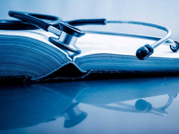 Book with stethoscope representing education