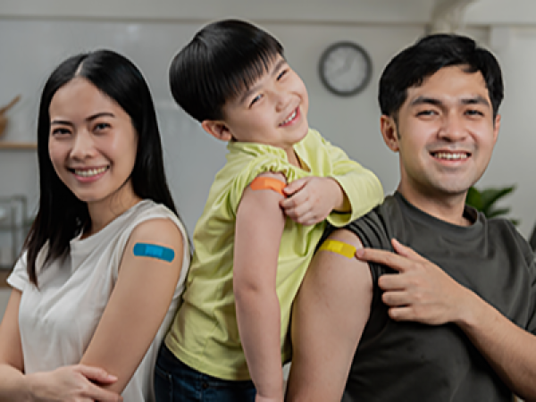 A family shows the bandages on their arms.