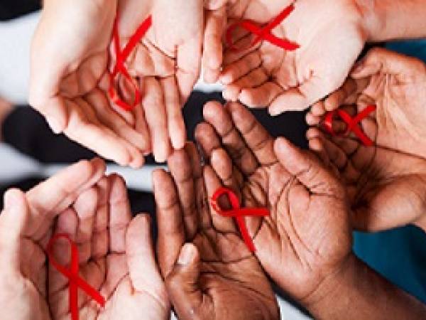 AIDS awareness ribbons in hands