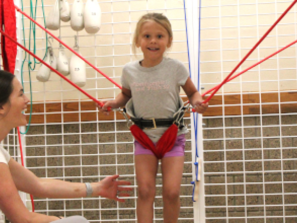 Therapist treating young child with bounce therapy 