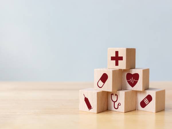 Stacked wood blocks with medical symbols