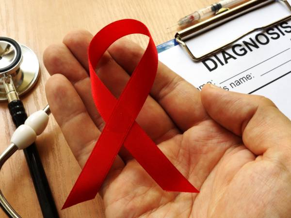 HIV Ribbon in a Providers Hand