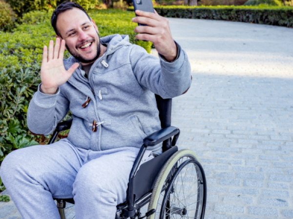 Man in wheelchair taking selfie