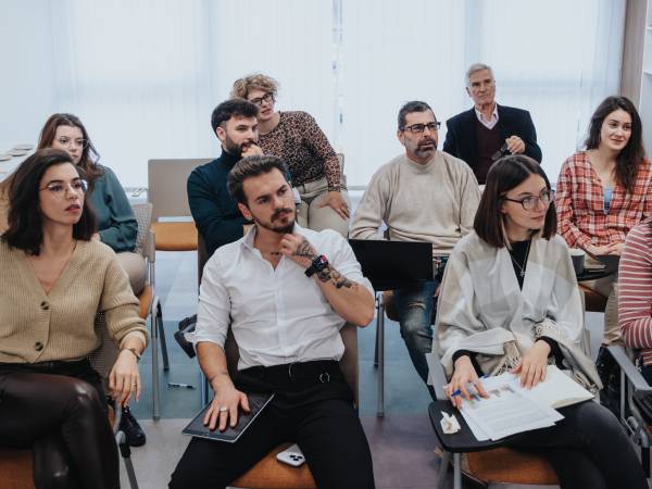 Group of people sitting at their desks training for work