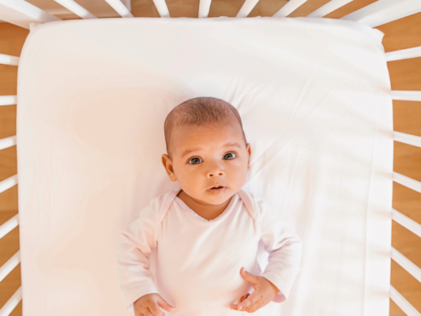 Baby in crib looking at the camera