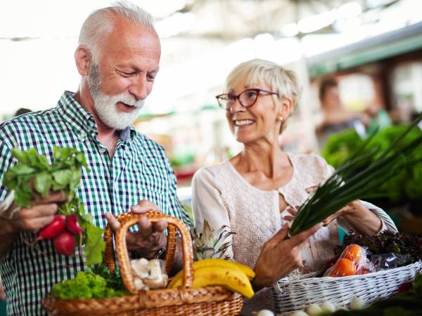 older adult couple grocery shopping for healthy food